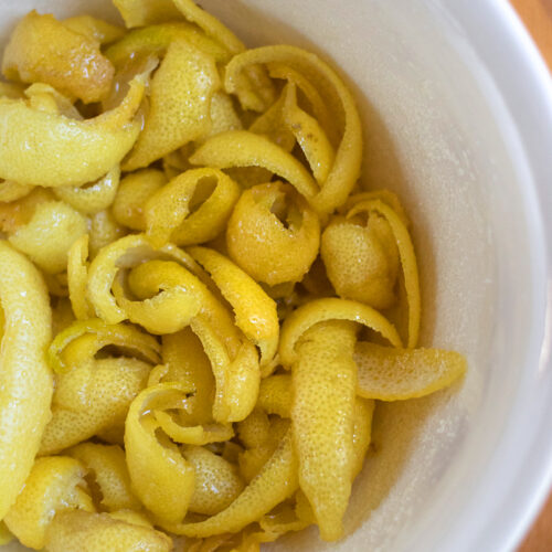 lemon peels and sugar in a mixing bowl.