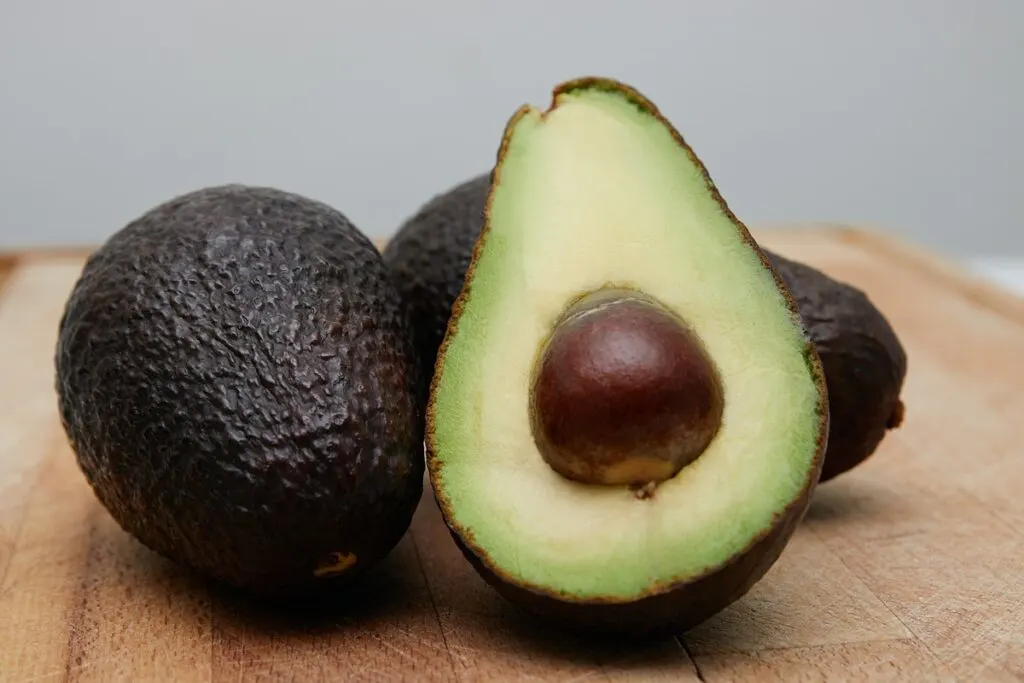 Sliced avocado fruit on brown wooden table