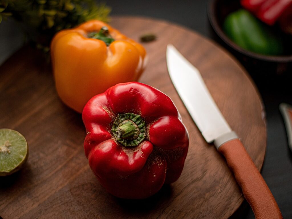 Red and yellow bell peppers on the cutting board