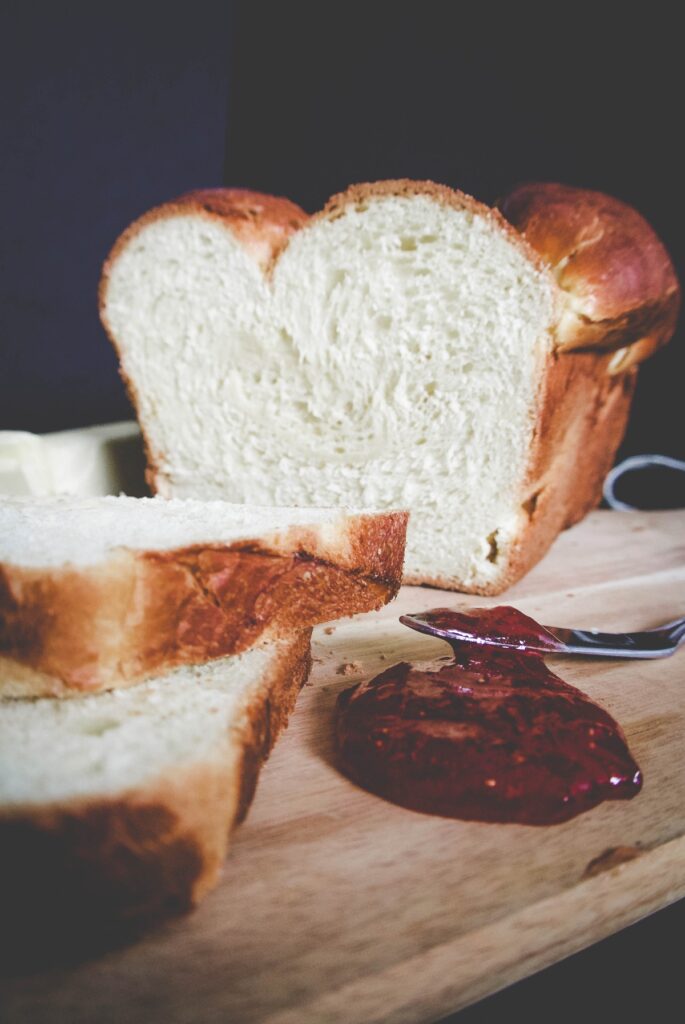 Loaf bread and pepper jelly on a wooden board